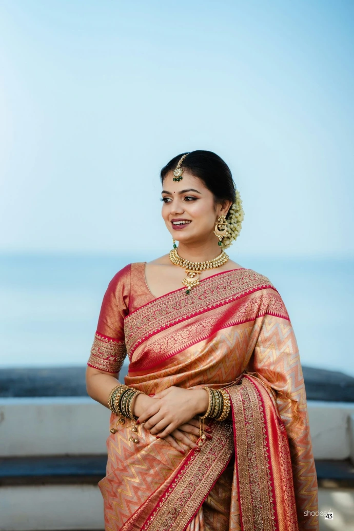 A woman in a sari posing for a picture